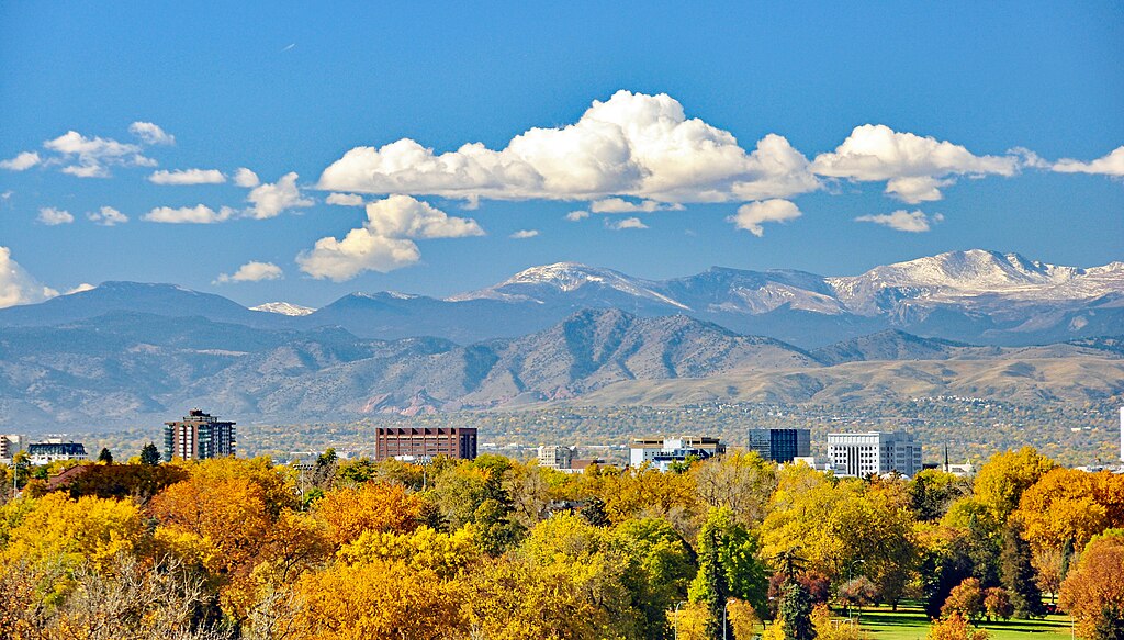 View of downtown Denver against a backdrop of the Rocky Mountains